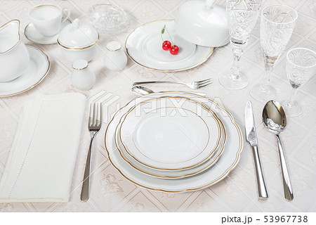 Two cherries lie on a white porcelain plate Two cherries lie on a white porcelain plate 53967738