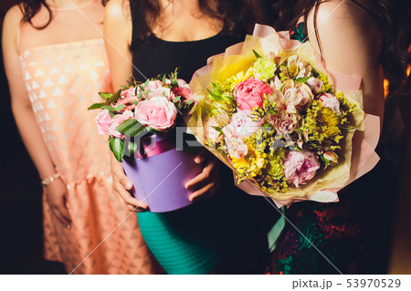 Two Small Beautiful bouquets of mixed flowers in woman hand. Floral shop concept . Beautiful fresh 53970529