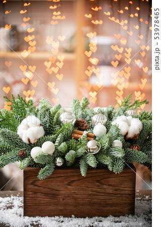 Christmas mood. Beautiful festive arrangement of fresh spruce in a rustic wooden box. Bokeh hearts Christmas mood. Beautiful festive arrangement of fresh spruce in a rustic wooden box. Bokeh hearts 53978465
