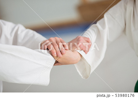 Boy and aikido teacher shaking hands before starting fight 53980176