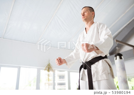 Young but experienced aikido master showing his fists 53980194
