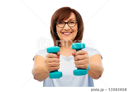 smiling senior woman with dumbbells exercising 53983608