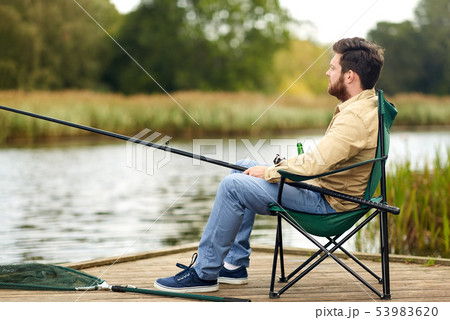 bearded fisherman with fishing rod at lake bearded fisherman with fishing rod at lake 53983620