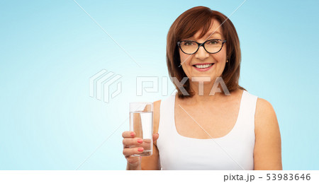 senior woman in glasses with glass of water senior woman in glasses with glass of water 53983646