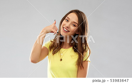 young woman or teenage girl showing call gesture young woman or teenage girl showing call gesture 53983647