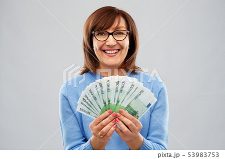 senior woman with hundreds of euro money banknotes senior woman with hundreds of euro money banknotes 53983753