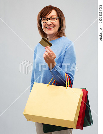 senior woman with shopping bags and credit card senior woman with shopping bags and credit card 53983755