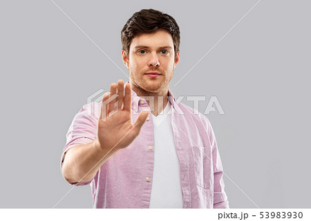 serious young man showing stop gesture serious young man showing stop gesture 53983930