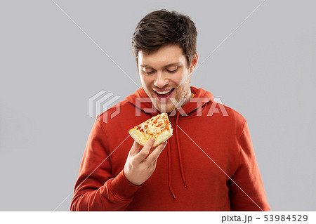 happy young man eating pizza 53984529