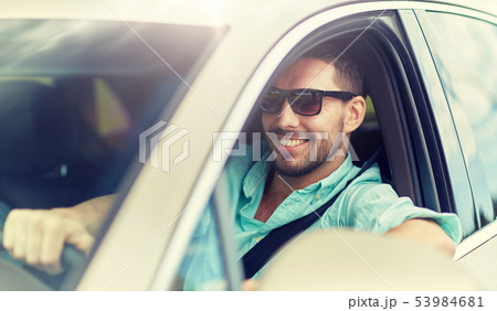 happy smiling man in sunglasses driving car happy smiling man in sunglasses driving car 53984681