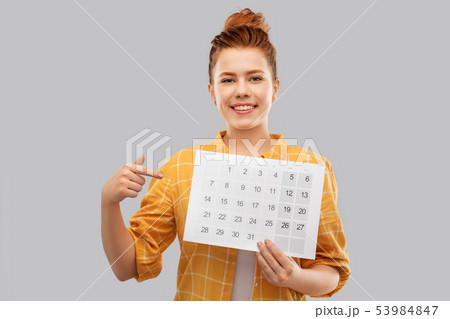happy red haired teenage girl with calendar sheet 53984847