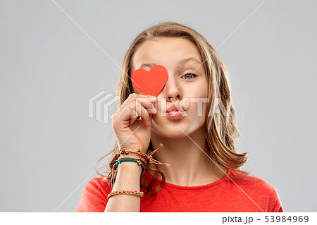 teenage girl covering eye with red heart 53984969