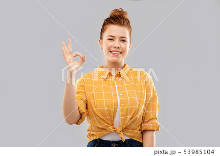 Happy Red Haired Teenage Girl Showing Ok Hand Signの写真素材