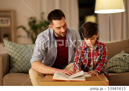 father and son doing homework together 53985615