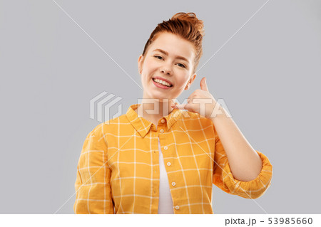 redhead teenage girl making phone call gesture 53985660