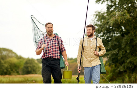 friends with fishing rods and net walking outdoors friends with fishing rods and net walking outdoors 53986108