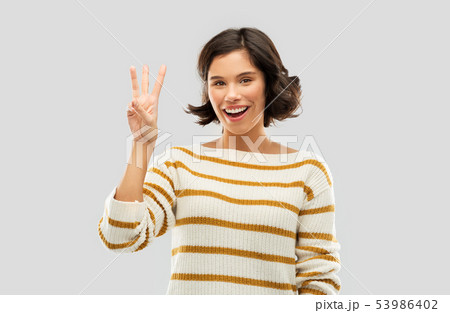 happy smiling woman showing three fingers happy smiling woman showing three fingers 53986402