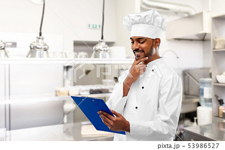 indian chef with clipboard at restaurant kitchen 53986527