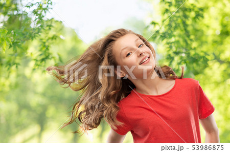 Smiling Teenage Girl Over Natural Backgroundの写真素材