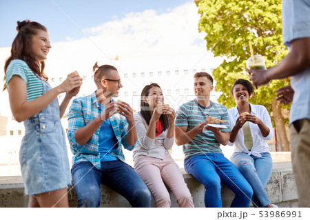 friends eating sandwiches or burgers in park friends eating sandwiches or burgers in park 53986991
