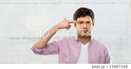 bored man shooting himself by finger gun gesture bored man shooting himself by finger gun gesture 53987108