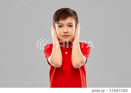 boy in red t-shirt closing ears by hands boy in red t-shirt closing ears by hands 53987280