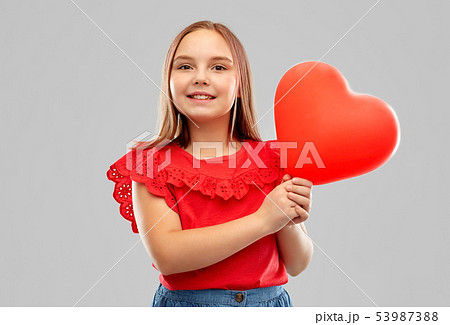 smiling girl with red heart shaped balloon smiling girl with red heart shaped balloon 53987388