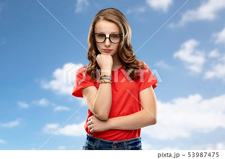 student girl in glasses thinking over sky 53987475