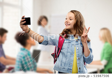 teenage student girl taking selfie by smartphone teenage student girl taking selfie by smartphone 53987506