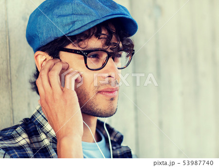 close up of man with earphones listening to music close up of man with earphones listening to music 53987740