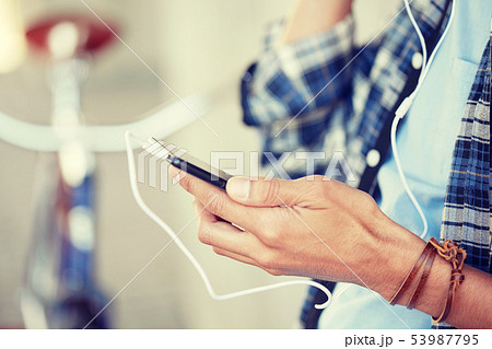 man with earphones and smartphone listening music 53987795