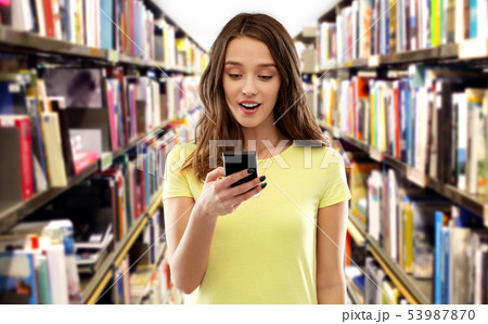 teenage student girl using smartphone at library teenage student girl using smartphone at library 53987870
