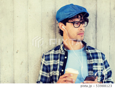 man with earphones and smartphone drinking coffee 53988123