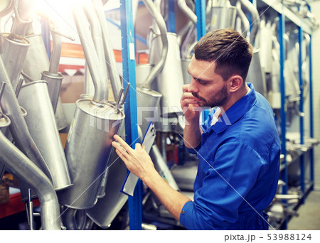 auto mechanic calling on phone at car shop auto mechanic calling on phone at car shop 53988124