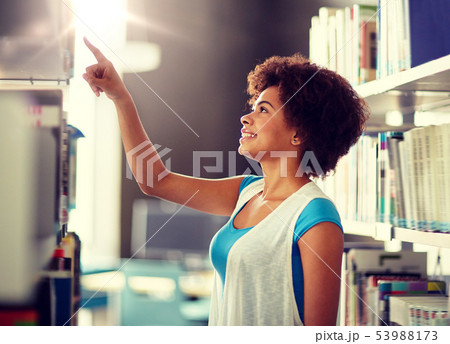 african student girl pointing to book at library african student girl pointing to book at library 53988173