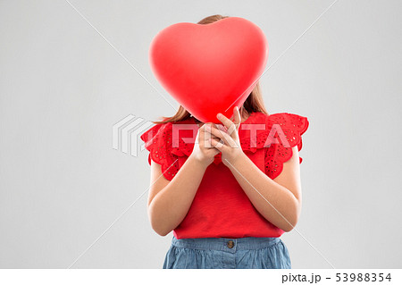girl hiding behind red heart shaped balloon 53988354
