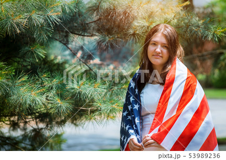 Young girl with classic dress holding american Young girl with classic dress holding american 53989236