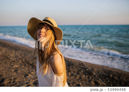 Young happy girl relaxing at the beach. Young happy girl relaxing at the beach. 53990498