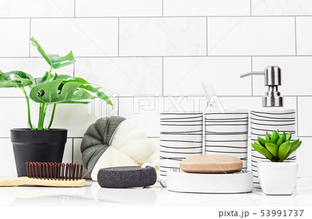 Herb soap, shower sponge and small green tree. 53991737