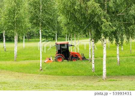 Tractor mowing grass Tractor mowing grass 53993431