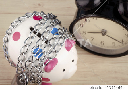 piggy bank,chains and padlock on wooden desk piggy bank,chains and padlock on wooden desk 53994664