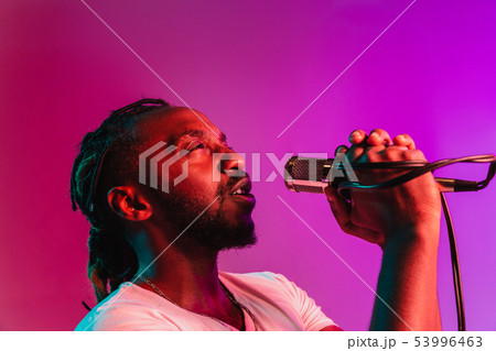 Young african-american jazz musician singing a song Young african-american jazz musician singing a song 53996463