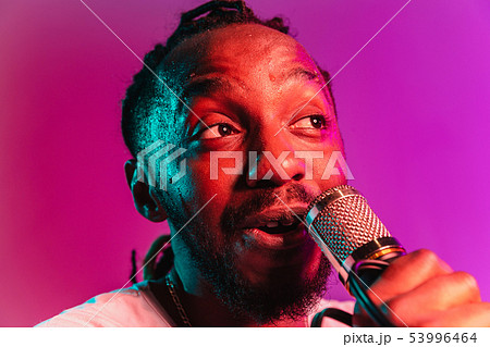 Young african-american jazz musician singing a song 53996464