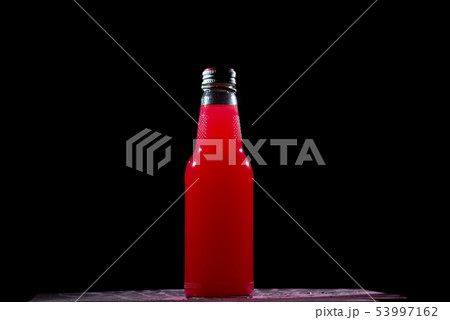 red bottle on dark background 53997162