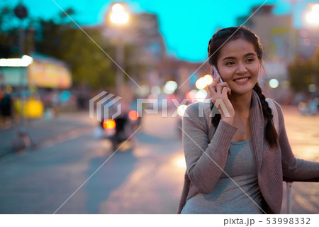 Young beautiful Asian tourist woman exploring Nakhon Pathom prov 53998332