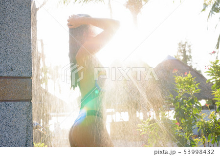 Young beautiful Asian tourist woman taking shower Young beautiful Asian tourist woman taking shower 53998432