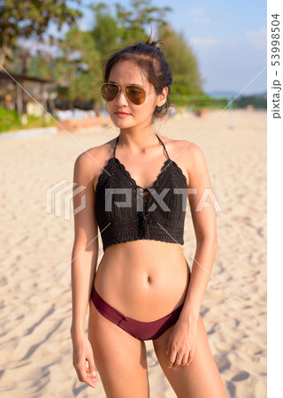 Young beautiful Asian tourist woman enjoying vacation Young beautiful Asian tourist woman enjoying vacation 53998504