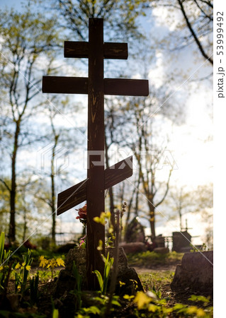 Grave cross on the Orthodox Christian cemetery at sunny day. 53999492