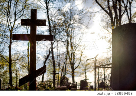 Grave cross on the Orthodox Christian cemetery at sunny day. Grave cross on the Orthodox Christian cemetery at sunny day. 53999493