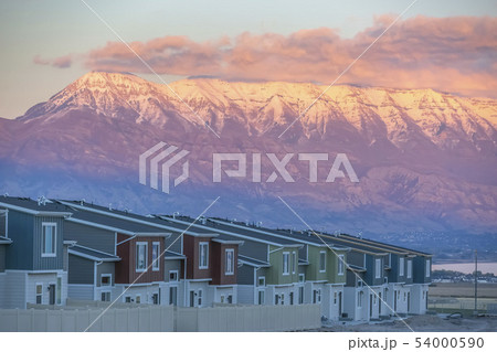 Homes against Mount Timpanogos lit by setting sun 54000590